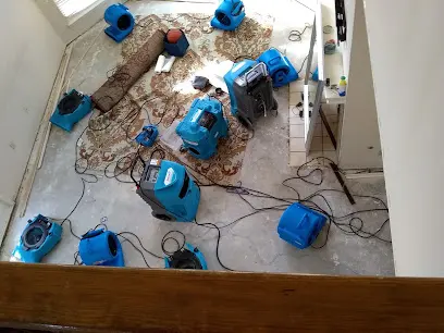 Air movers drying a floor after a water loss in Converse, TX