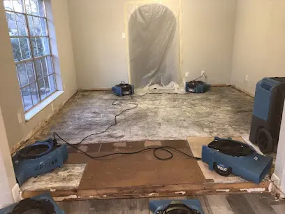Air movers drying a room after water damage