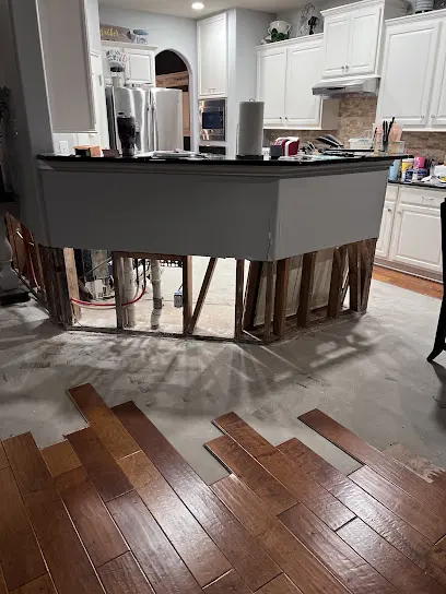 Air movers drying a water damaged room